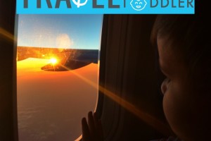boy looking out window at a plane: travel do's & don'ts with a toddler