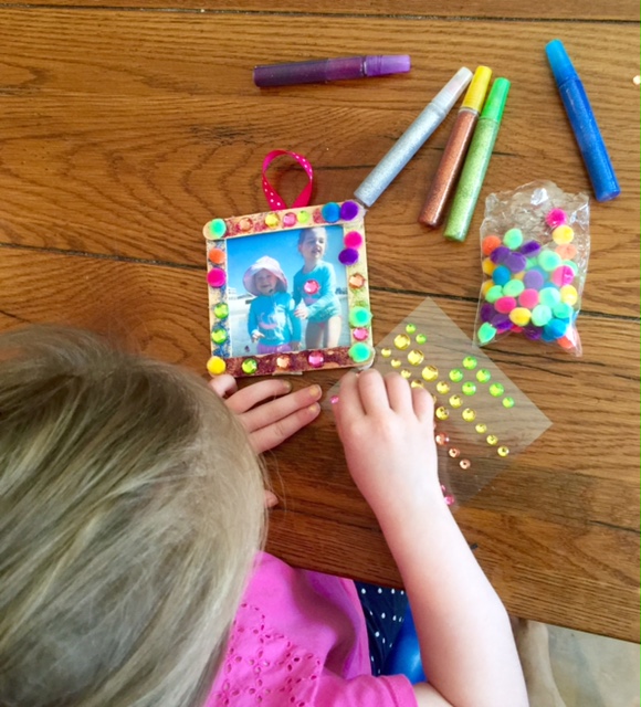 Messy toddler-made popsicle stick frame will make you smile for years to come
