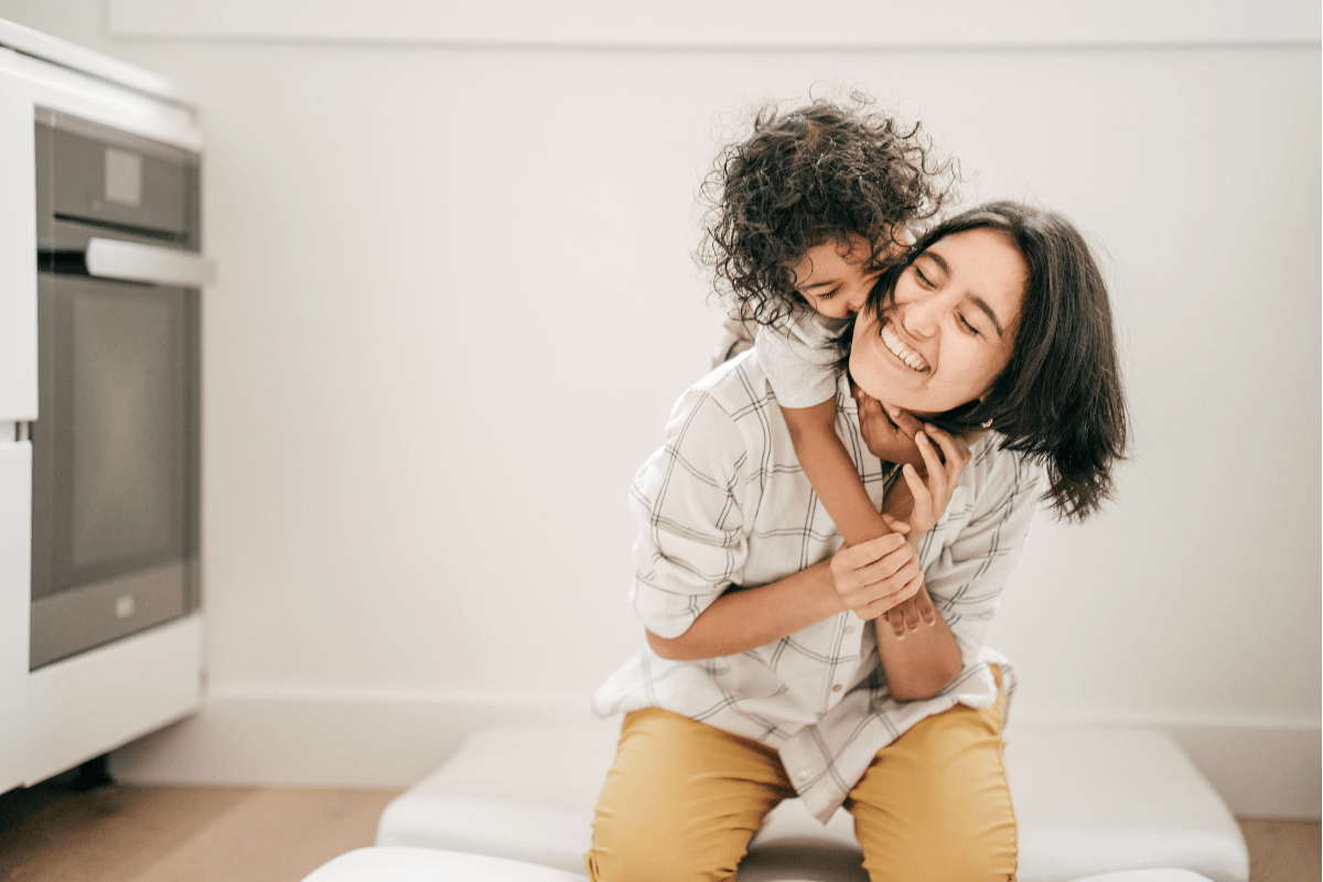 mom and child hugging in kitchen (minimalist mom, minimalism)