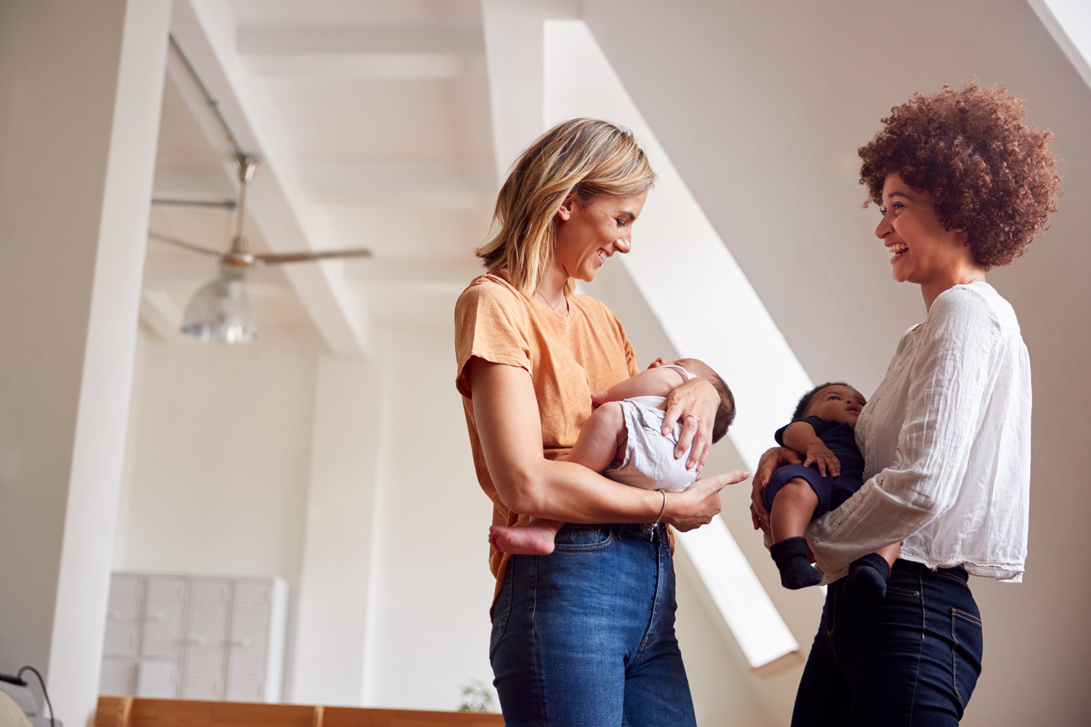 Two Mothers Meeting Holding Newborn Babies At Home (be the nicest mom in the room)
