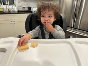 Child eating in a high chair
