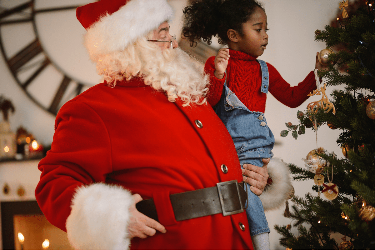 Santa holding little girl (where to find Santa in Boston)