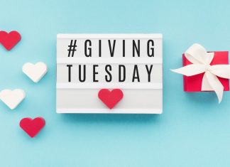 #GivingTuesday on a blue background with red and white hearts.