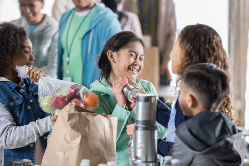 children volunteering at a food bank (where to volunteer with kids in Boston)