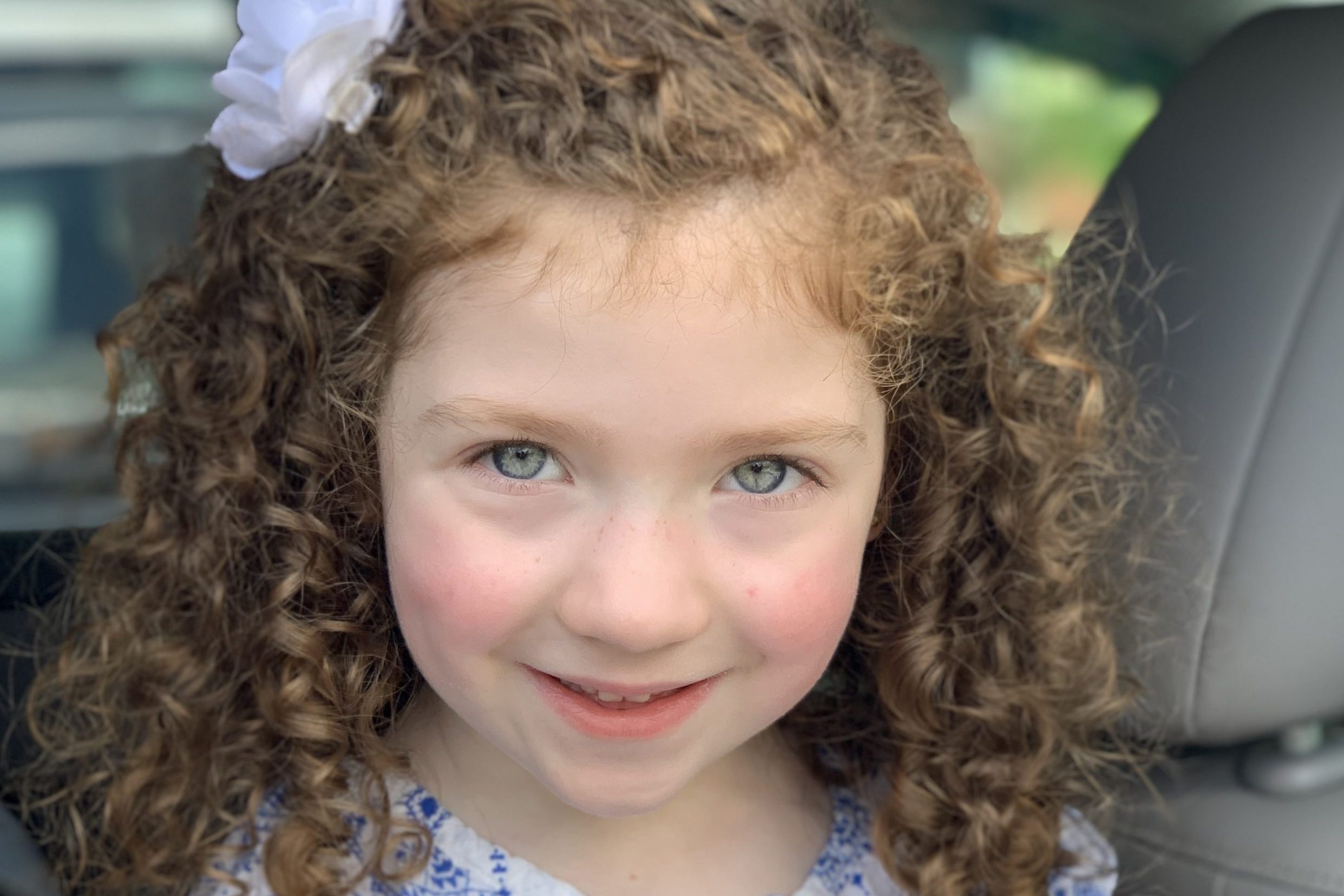 girl with curly hair and blue eyes