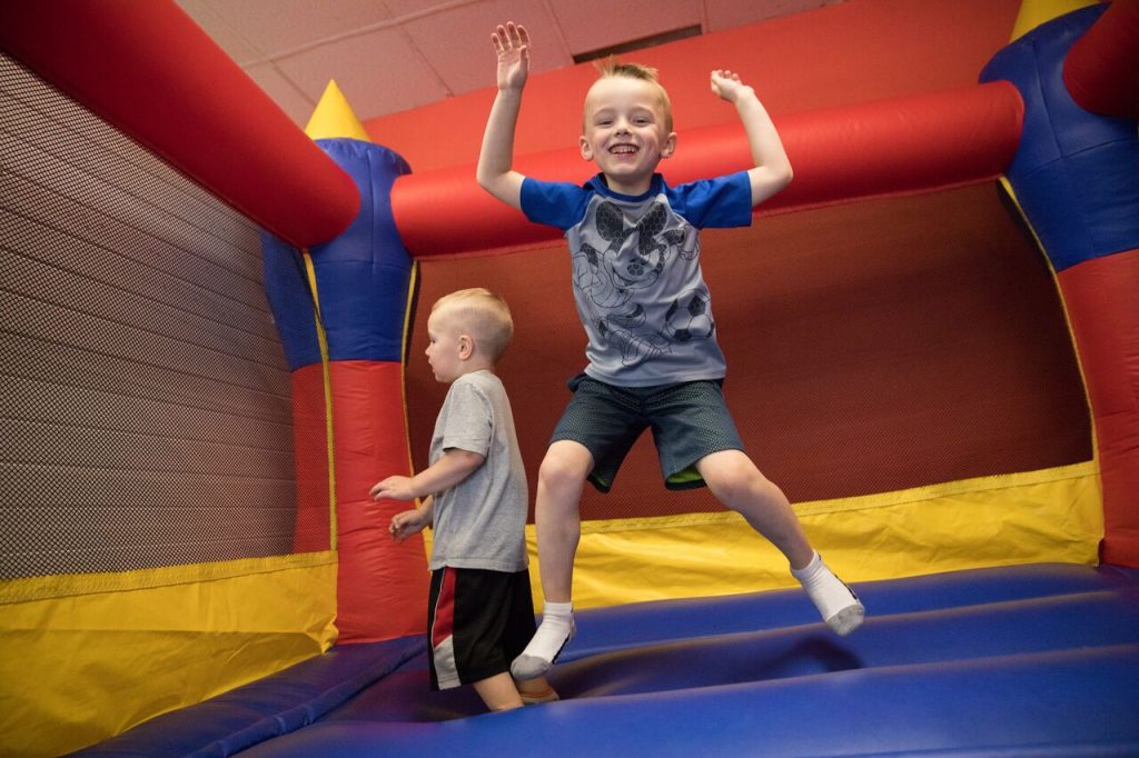 boys jumping on inflatable castle