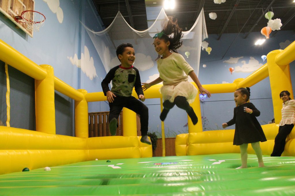 Kids jumping on indoor inflatable play ground