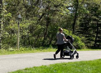 Woman walking with baby stroller