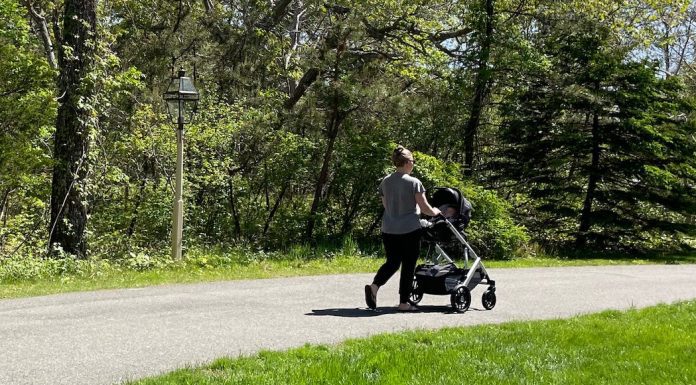 Woman walking with baby stroller