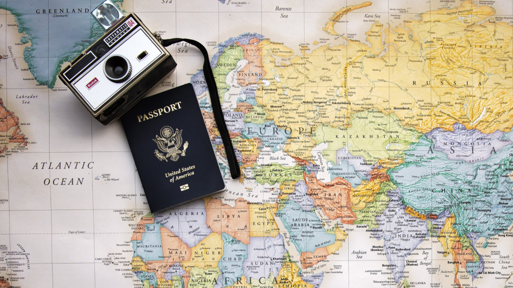 studying abroad in college with a map, passport and camera