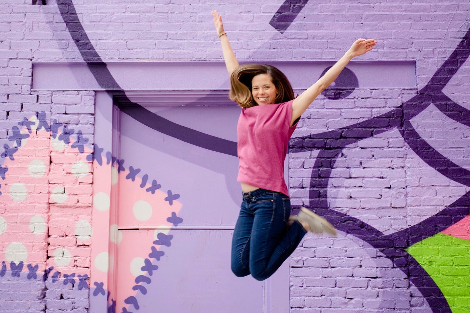 woman jumping in the air, feeling free and happy because of her social media break
