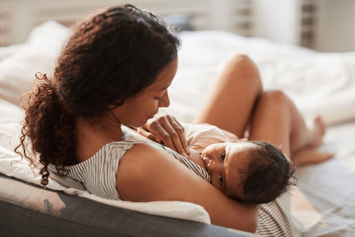 woman breastfeeding baby at home
