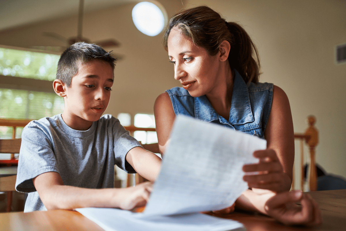 parent helping child with homework (child is not on the honor roll and I am proud, parent-teacher conferences)