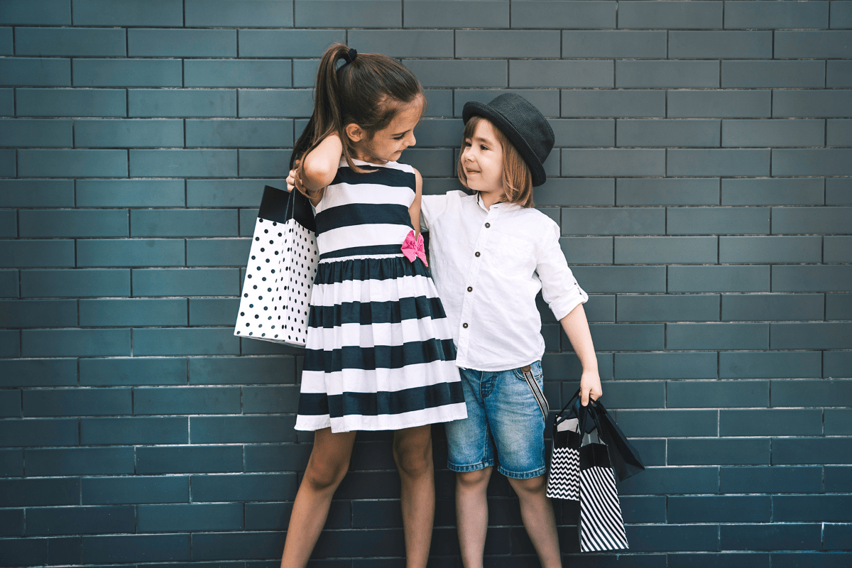 two children holding shopping bags (kids resale and consignment shops in Boston)