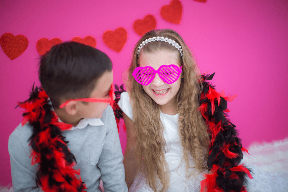 two children with Valentine's Day decor (Valentine's things to do in Boston with kids)