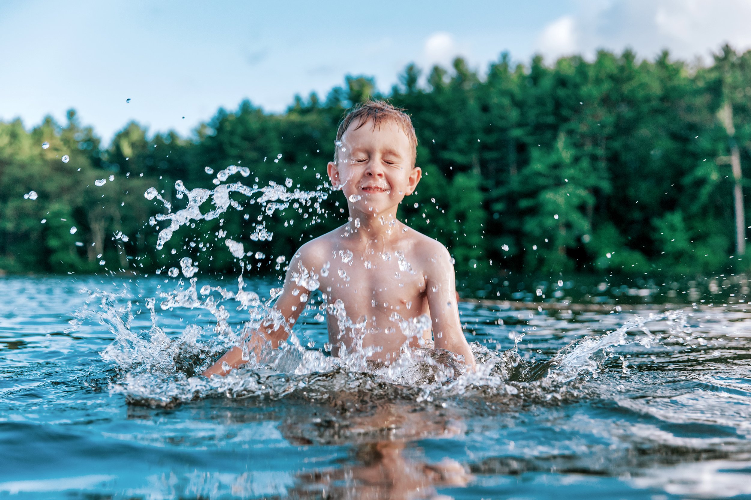boy splashing in a swimming pond or lake (swimming holes boston massachusetts)